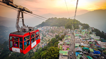 The iconic Gangtok Ropeway offering stunning sunset views over the city, a key attraction in our Sikkim tour packages.