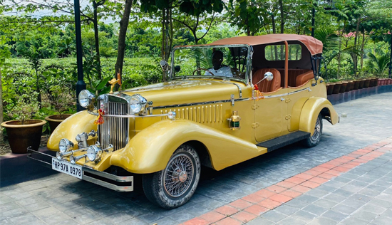 Vintage car, featuring a classic white convertible beautifully decorated with custom flowers for an unforgettable entrance.